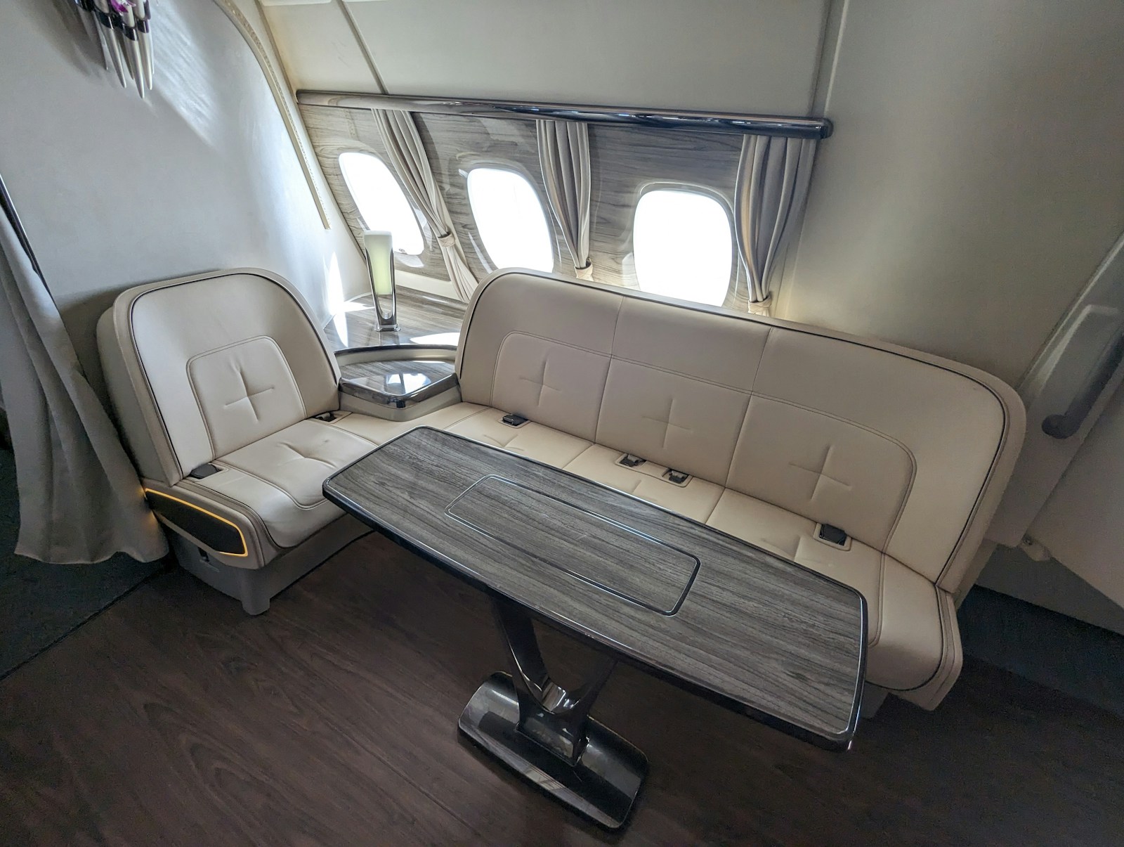 First-class cabin — cream leather seats and champagne by the window